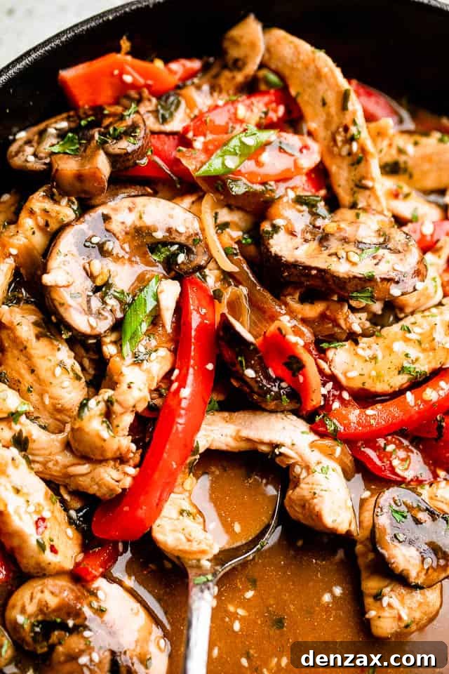 This better than takeout chicken stir fry recipe is packed full of fresh veggies and covered in a flavor-packed garlic and ginger sauce. cooked chicken, mushrooms, and peppers in a wok