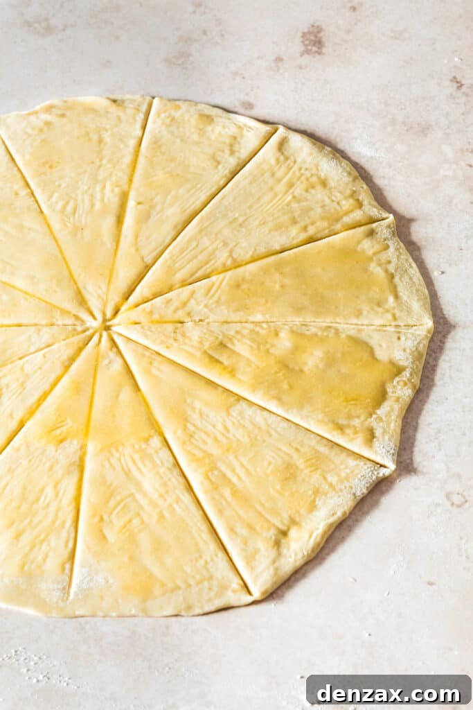Dough rolled into a circle and cut into wedges, brushed with butter.