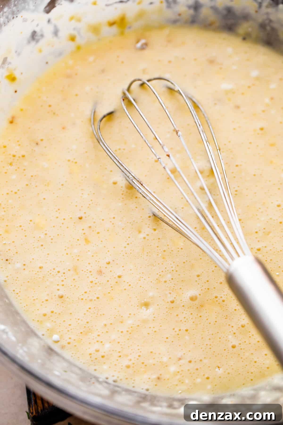 Melted butter, sugar, cornstarch, and cream in a glass mixing bowl.