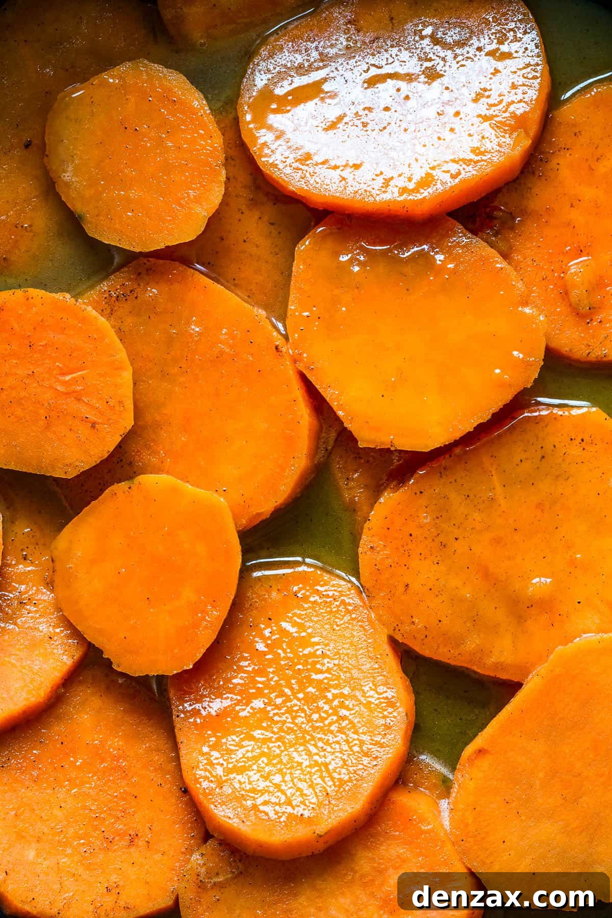 Sweet potatoes in syrup on a skillet.