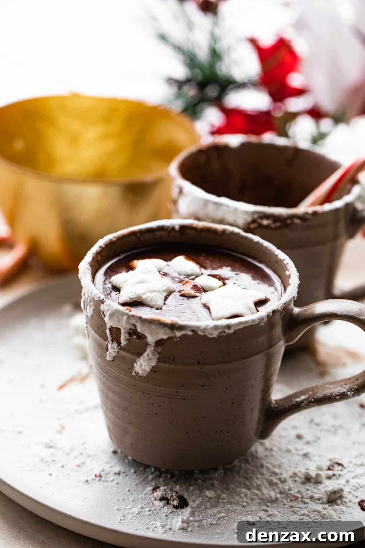 side shot of a brown mug filled with french hot chocolate and topped with marshmallows.