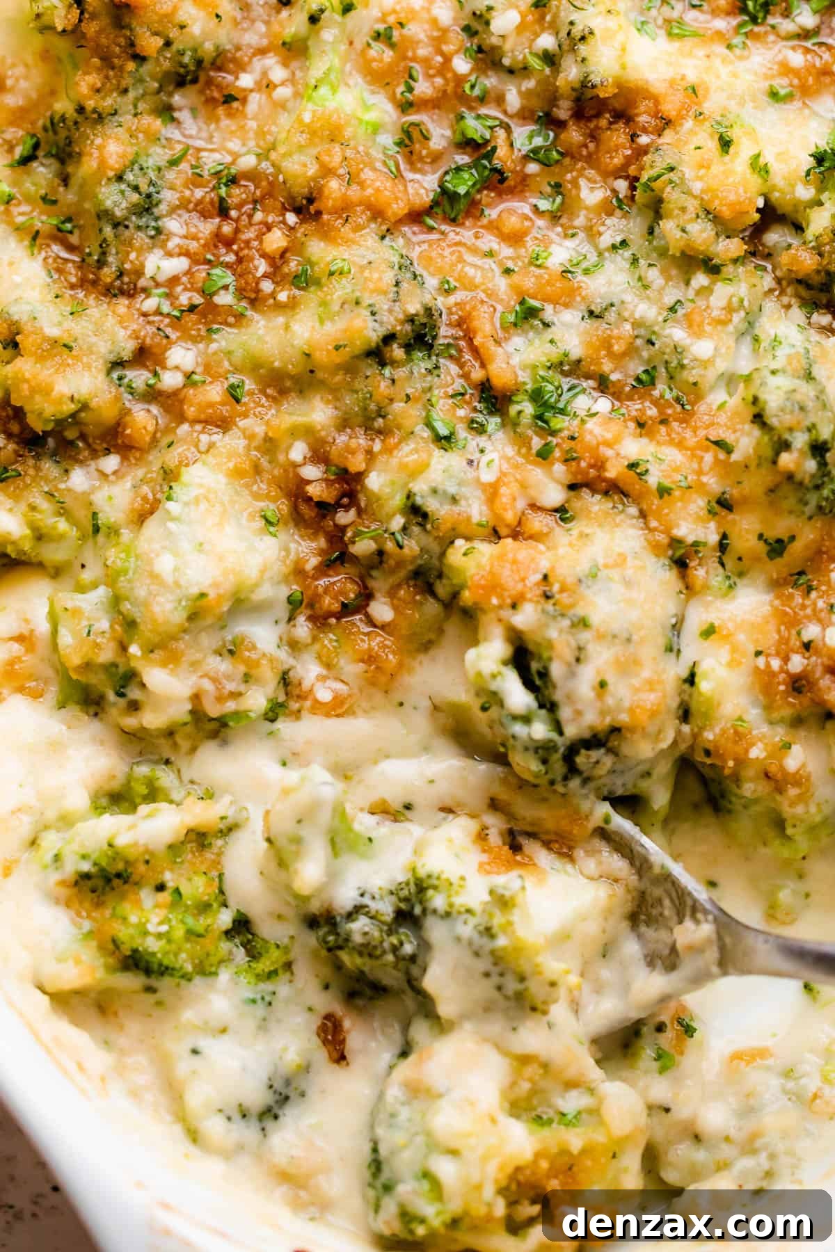 up close overhead shot of an oval baking dish with Cheesy Broccoli Casserole