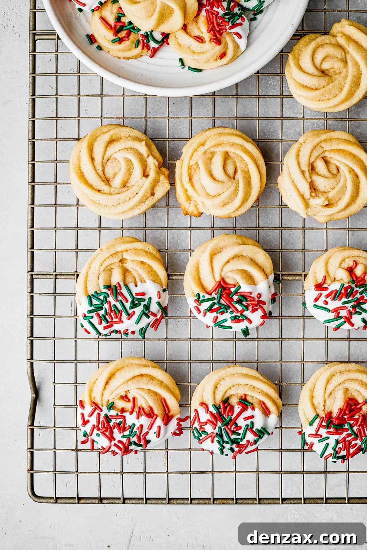 Decorated cookies drying on a cookie rack.