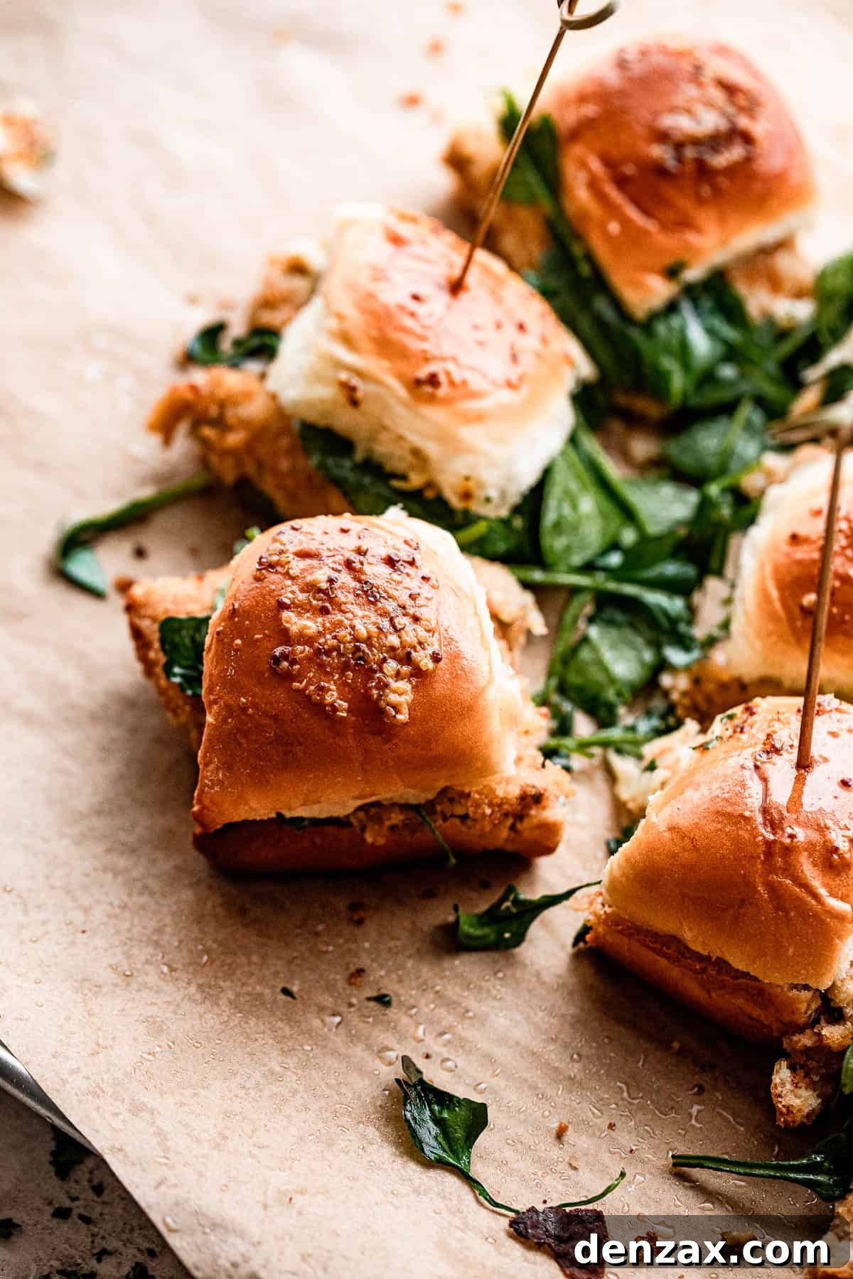 crab cake sliders arranged on brown paper.