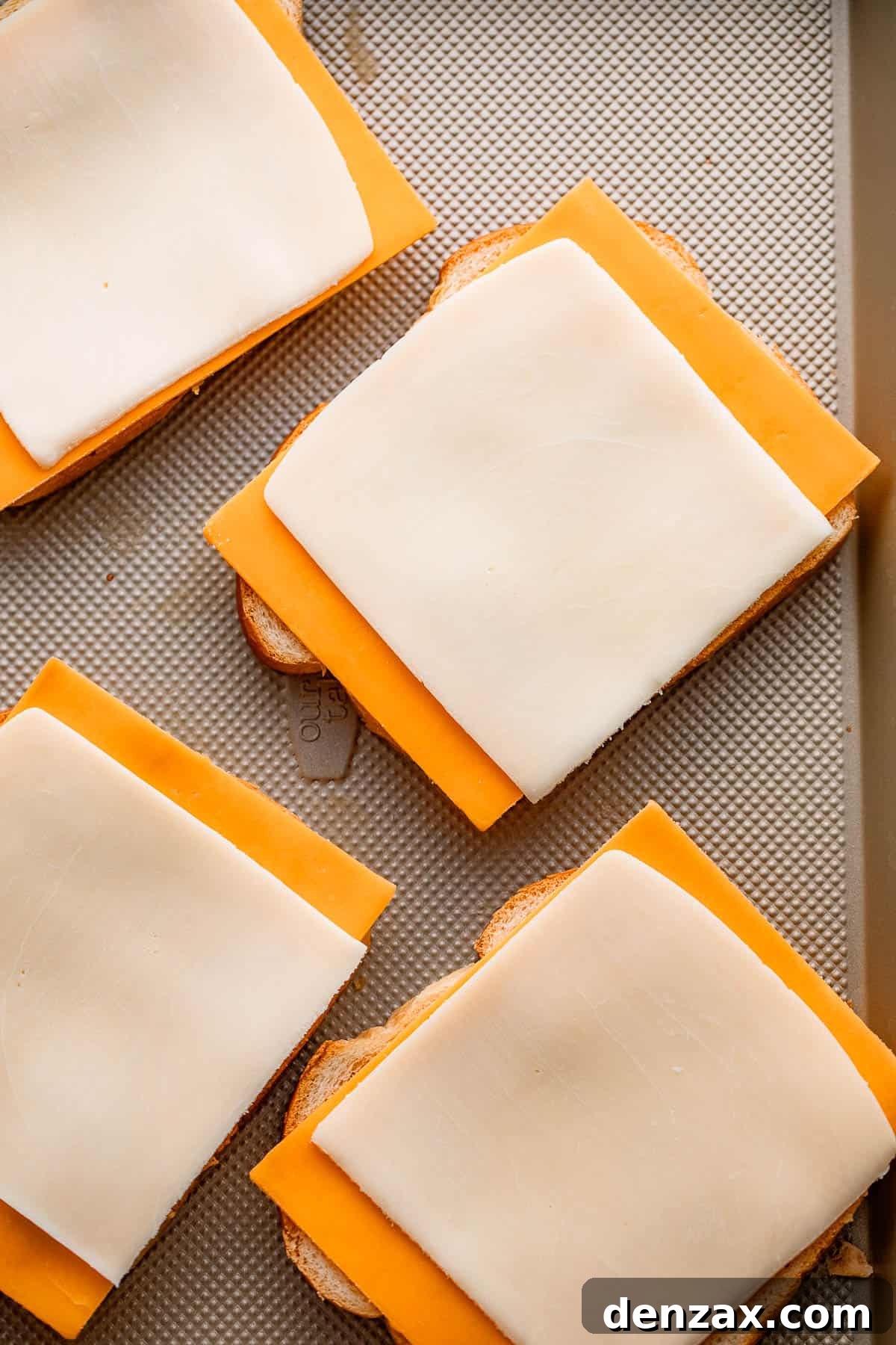 cheese slices set on top of four bread slices.