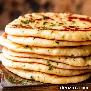 Stack of homemade flatbread on a wooden board.