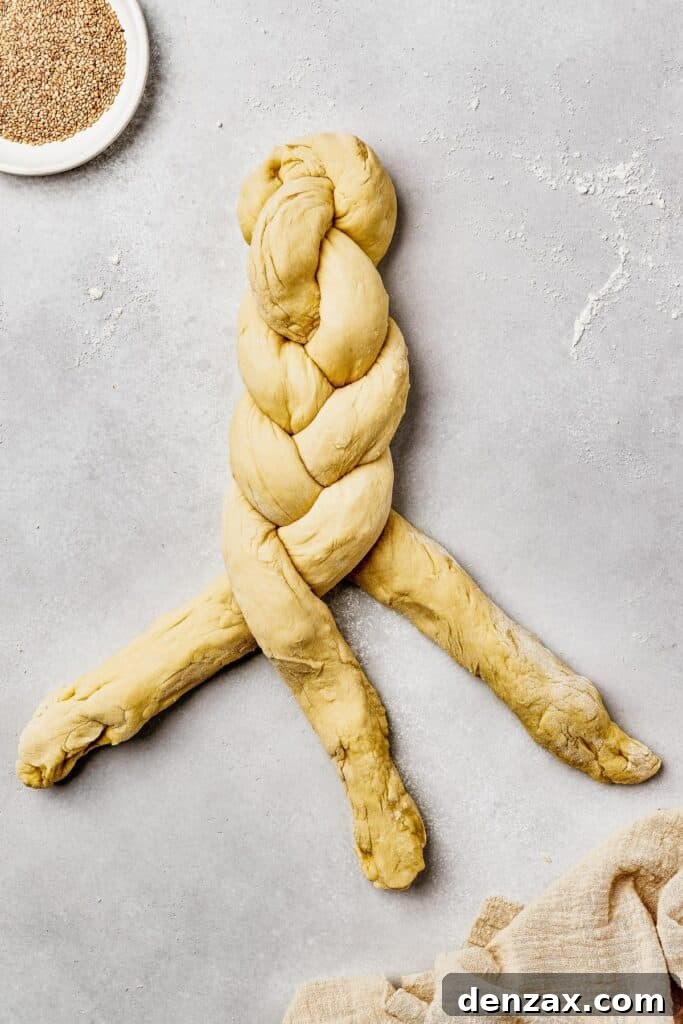Classic Homemade Challah Recipe: Soft, Fluffy Braided Bread 6 Three long pieces of dough being braided together.