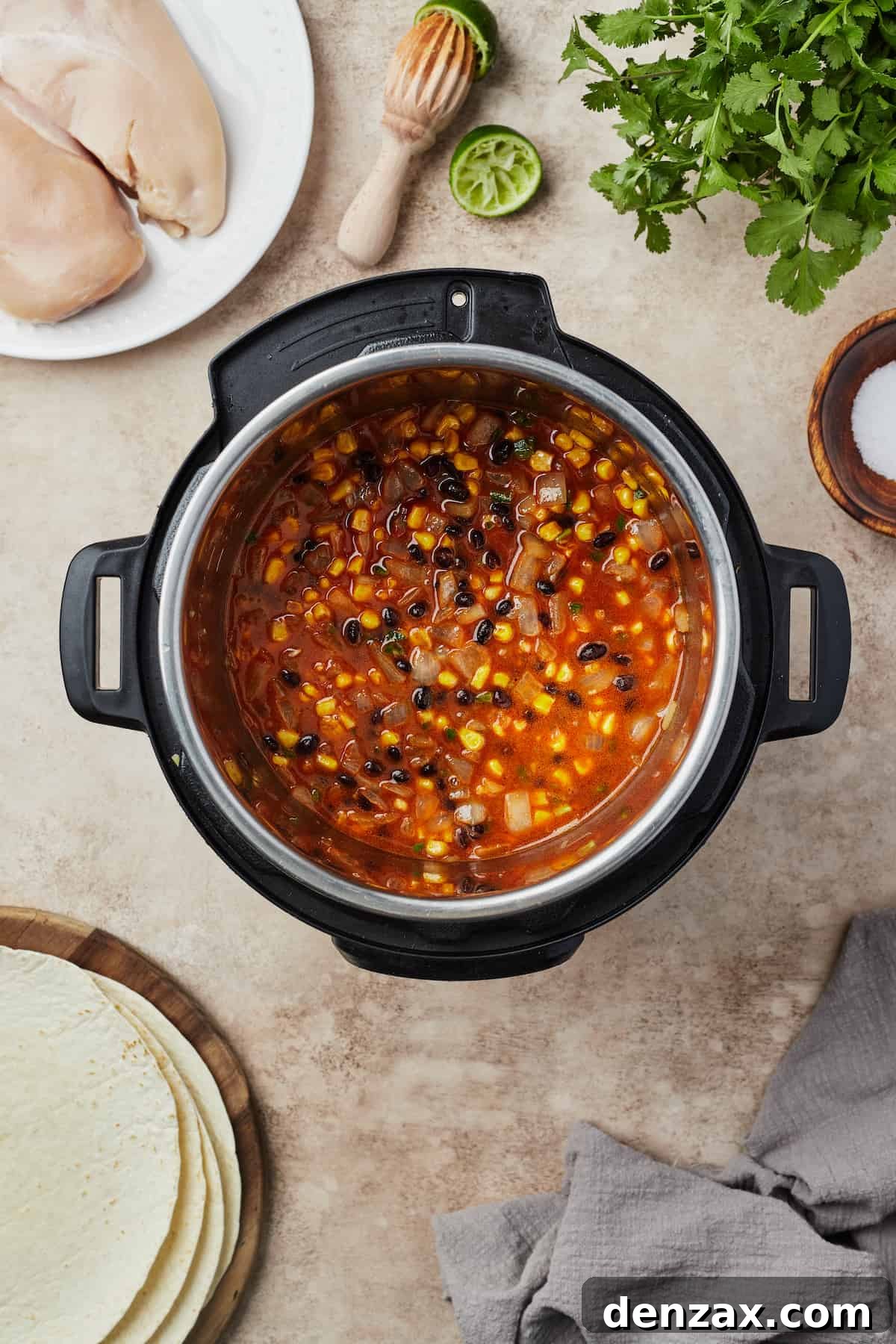 Easy Instant Pot Chicken Burritos Recipe — Quick & Flavorful Meal 6 Vegetables, beans, and other ingredients in an Instant Pot.