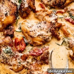 close up shot of boneless chicken thighs in a creamy sun dried tomato sauce.