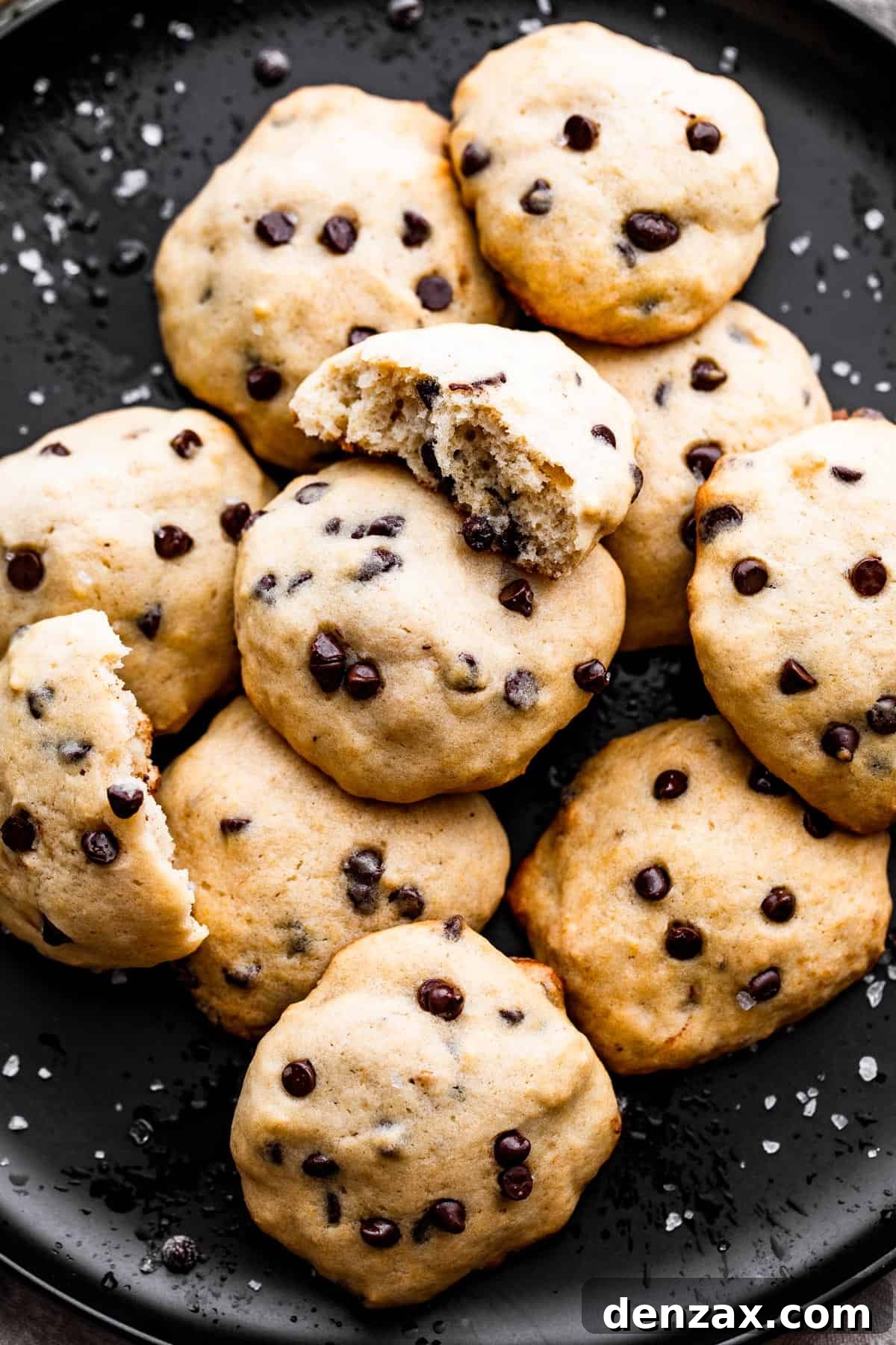 overhead shot of banana chocolate chips cookies served on a black plate.