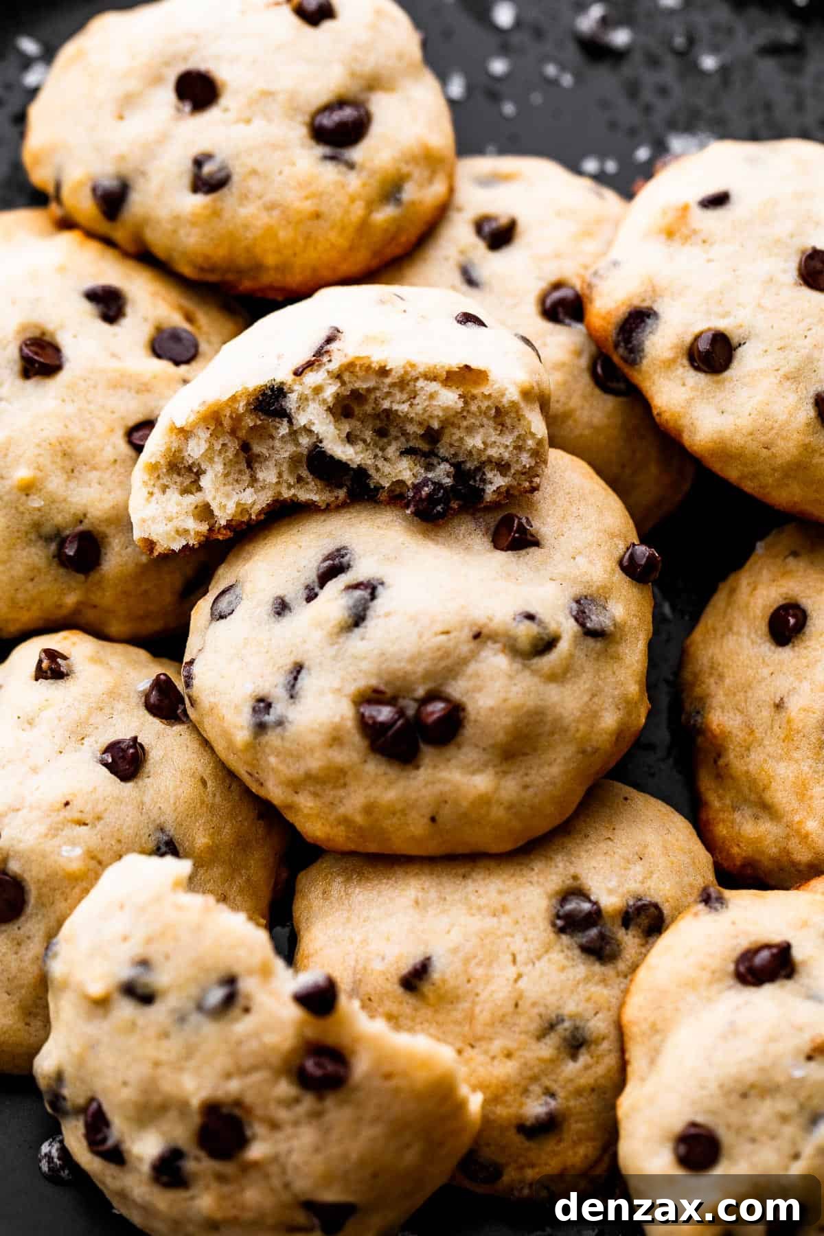 overhead up close shot of banana chocolate chips cookies served on a black plate.