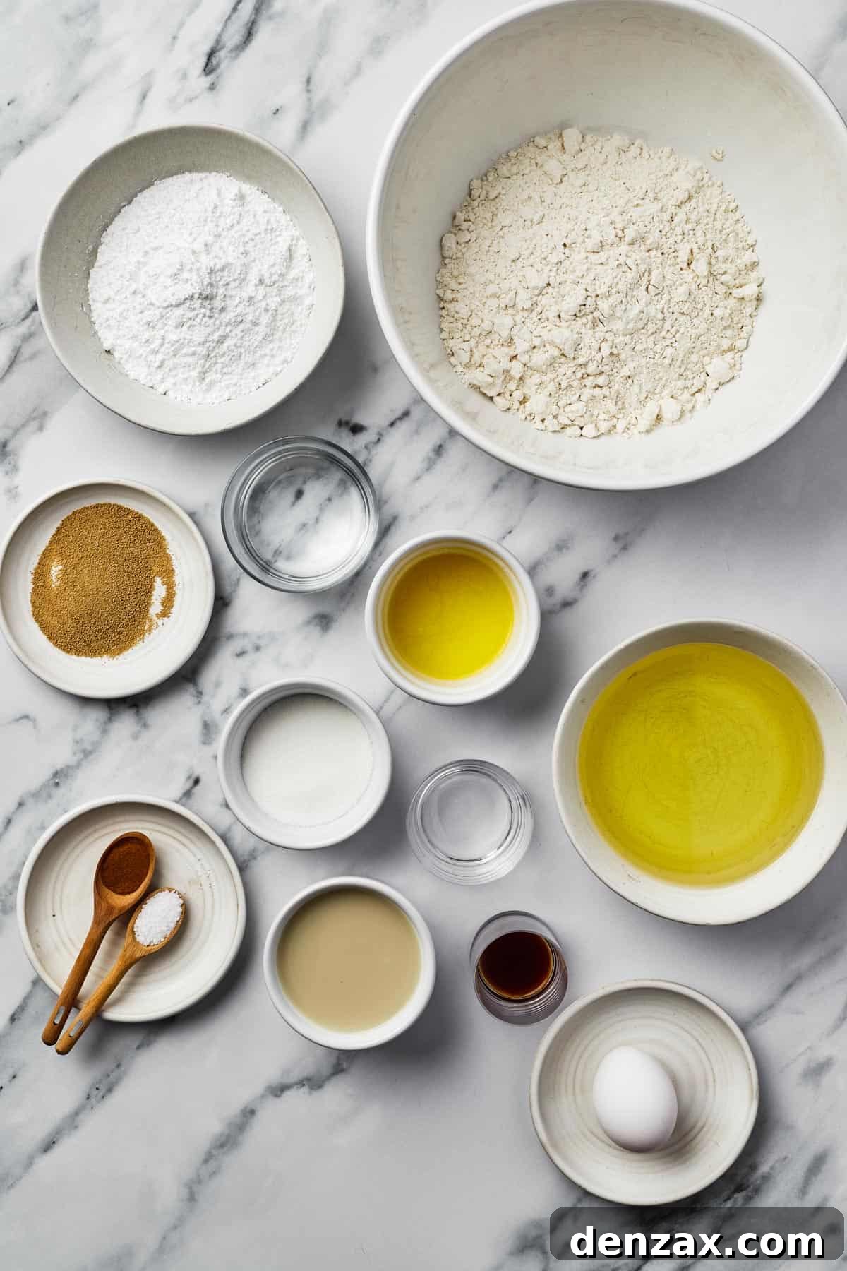 Ingredients for beignets: powdered sugar, flour, yeast, water, butter, oil, sugar, vinegar, cinnamon, salt, vanilla, egg.