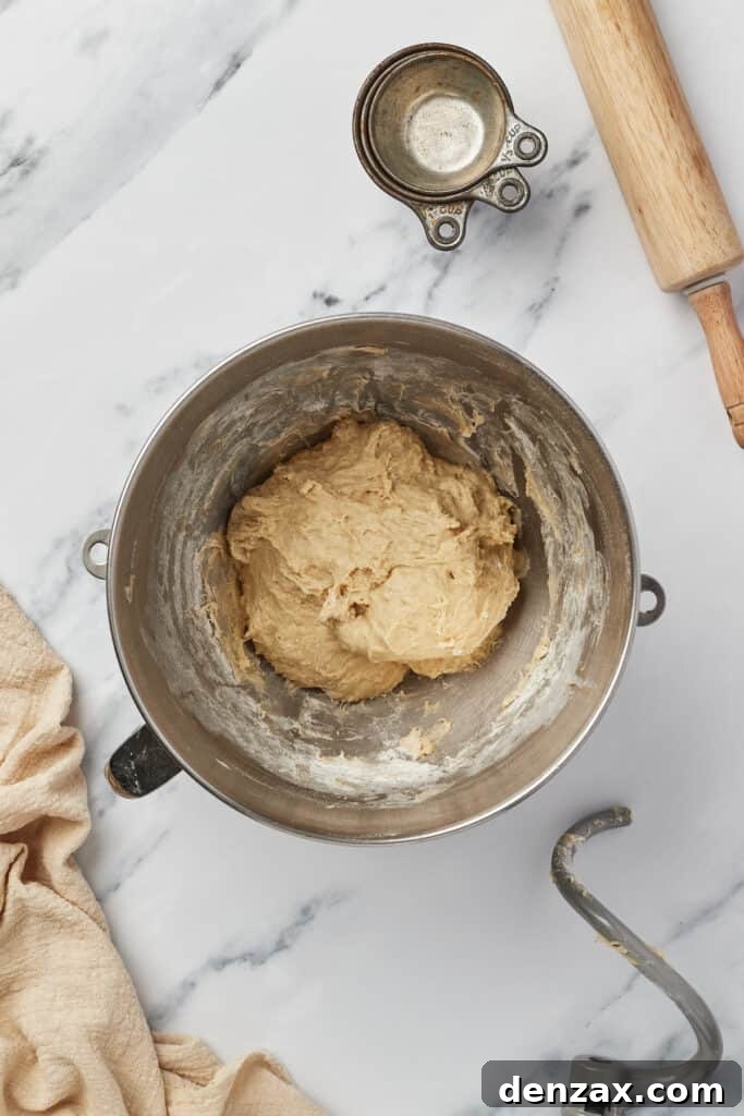 A soft dough in the bowl of a stand mixer.