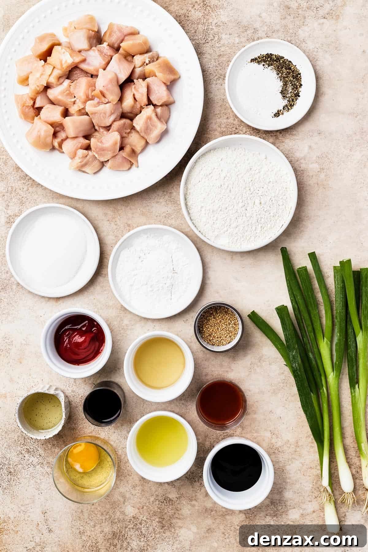 From top left: Chicken breast, salt and pepper, sugar, cornstarch, flour, ketchup, oil, toasted sesame seeds, rice vinegar, oyster sauce, sriracha, egg, pineapple juice, soy sauce, green onions.