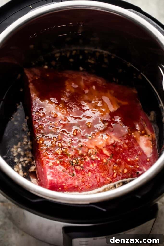 raw corned beef placed in the instant pot.