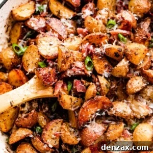 Crispy Roasted Potatoes with Bacon, Cheese, and Herbs 7 overhead shot of roasted potatoes and bacon in a white skillet.