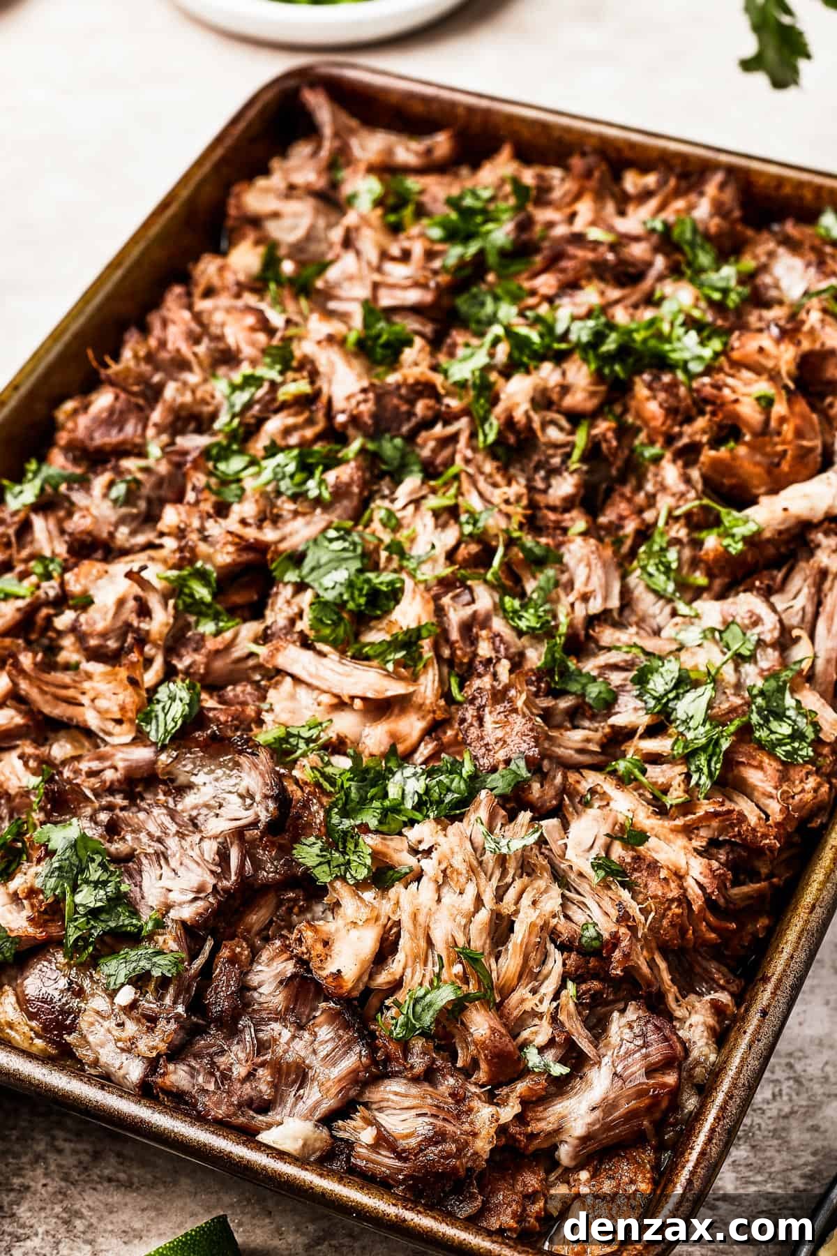 Crispy pork carnitas, garnished with fresh cilantro.