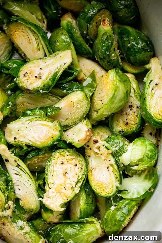 Tender brussels sprouts, slow cooked and tossed with Parmesan cheese. This easy side dish is perfect to serve with meat and potatoes! Fresh brussel sprouts, cut in half and seasoned.
