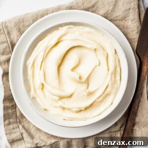A bowl of creamy white icing on a linen napkin.