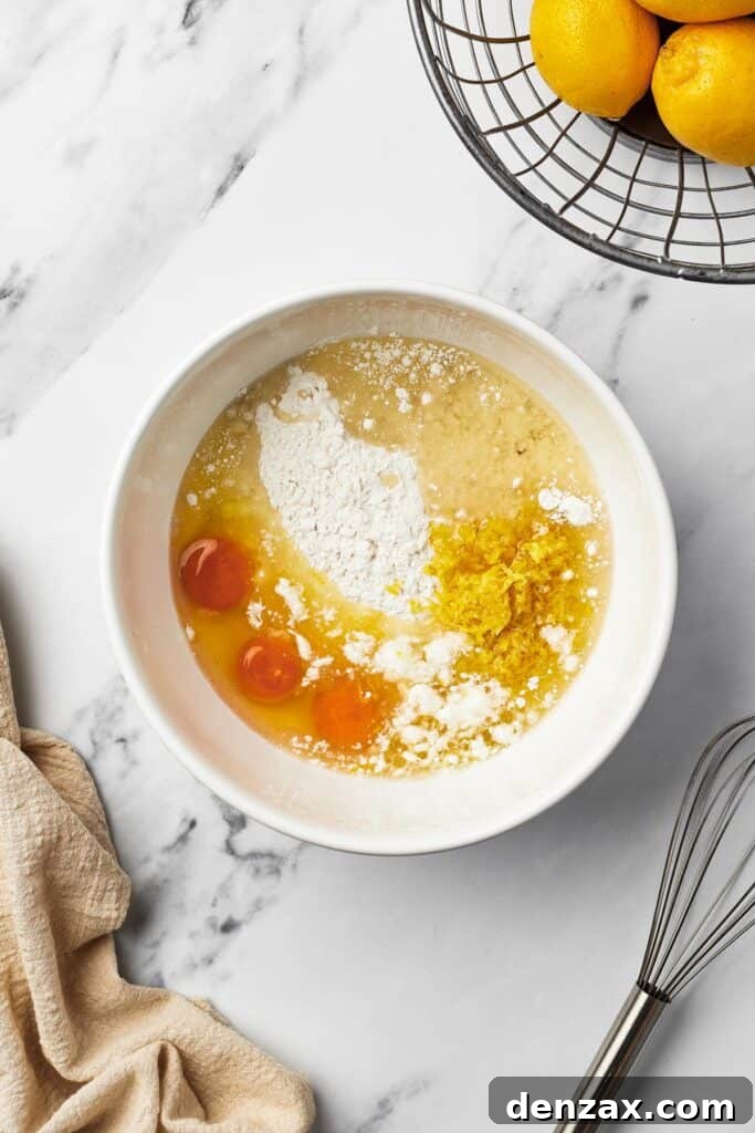 A mixing bowl with cake mix, raw eggs, and other ingredients inside.