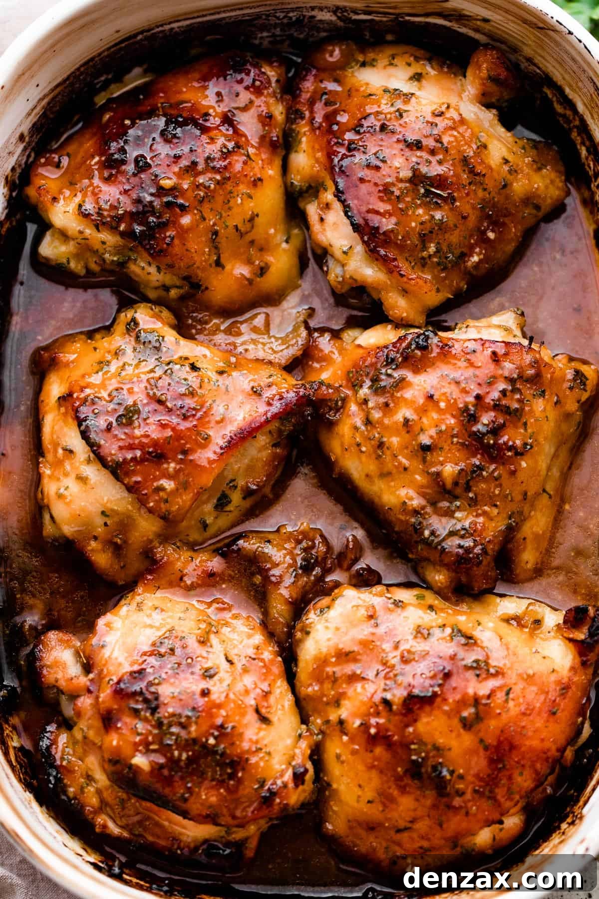 overhead shot of a baking dish with six honey garlic baked chicken thighs.