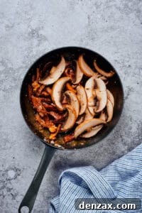 Beef and mushrooms in a skillet.