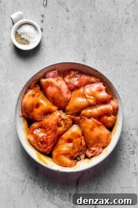 Boneless, skinless chicken thighs marinating in soy sauce.