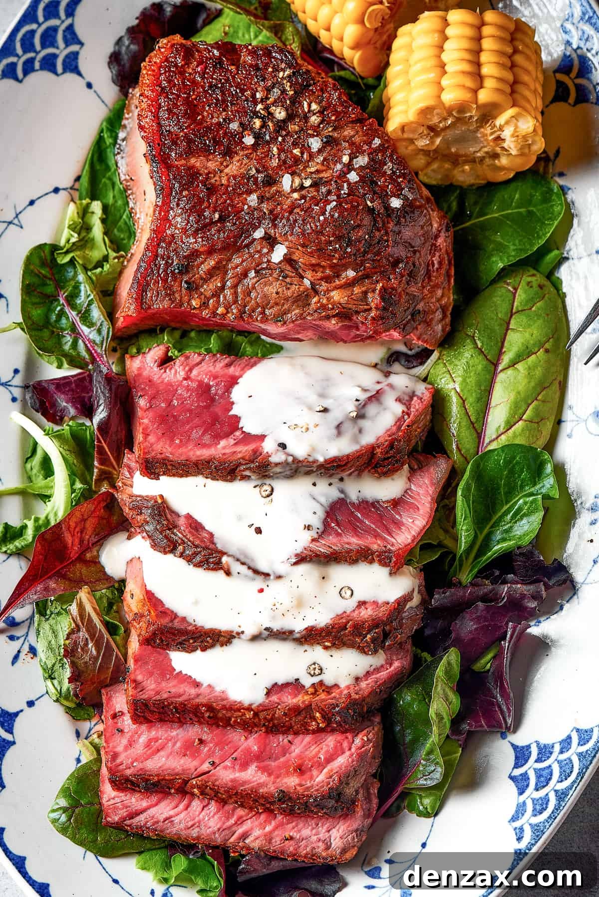 Sliced sirloin steak, with a drizzle of blue cheese sauce.