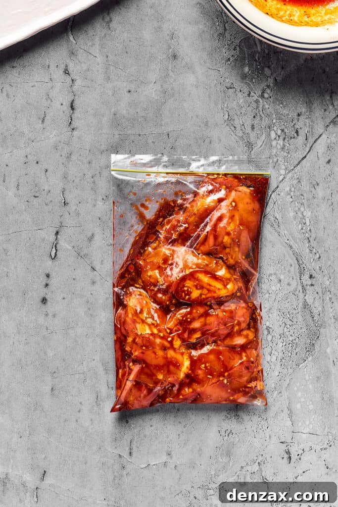Chicken thighs marinating in a zip-top bag.