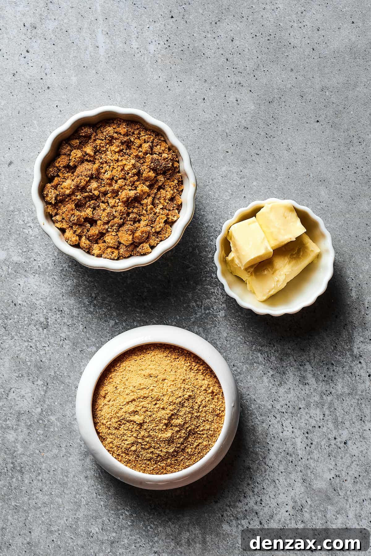 From top: Graham cracker crumbs, butter, and brown sugar in separate dishes.