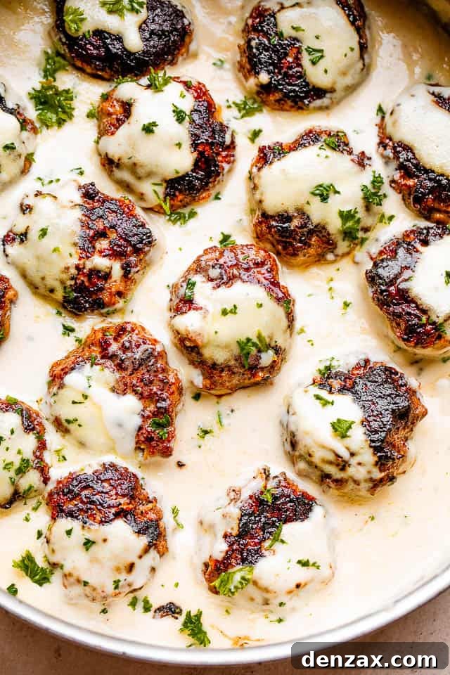 Swedish meatballs in sauce topped with fresh parsley.