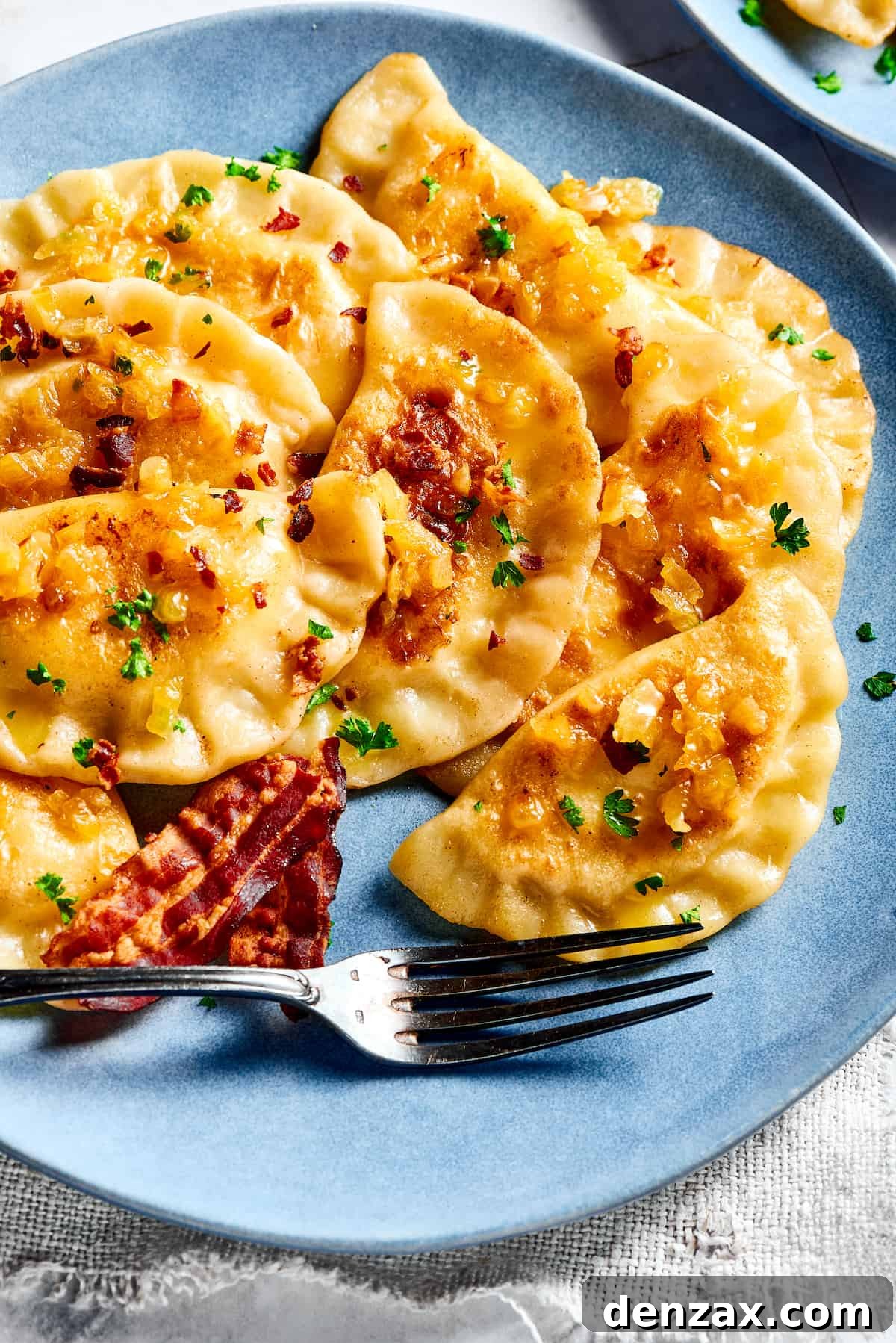 Bacon and onion topped pierogi ruskie.