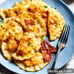 Homemade potato-filled dumplings on a blue plate with a fork.