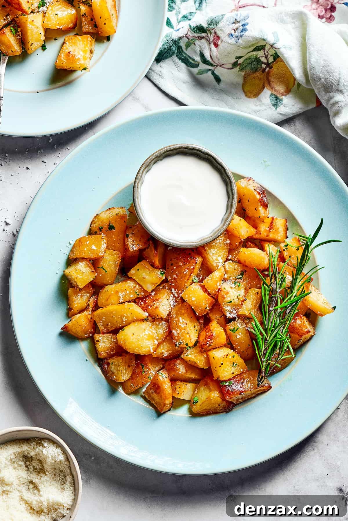 Seasoned potatoes with a cup of Greek yogurt sauce.