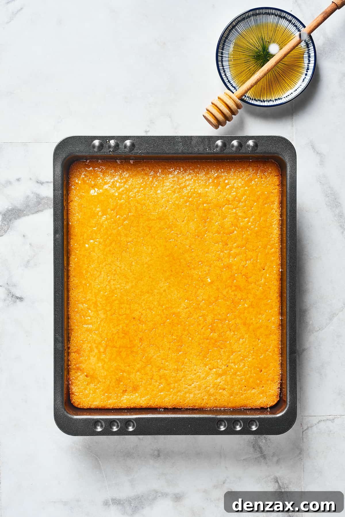 A loaf of cornbread in a baking dish.