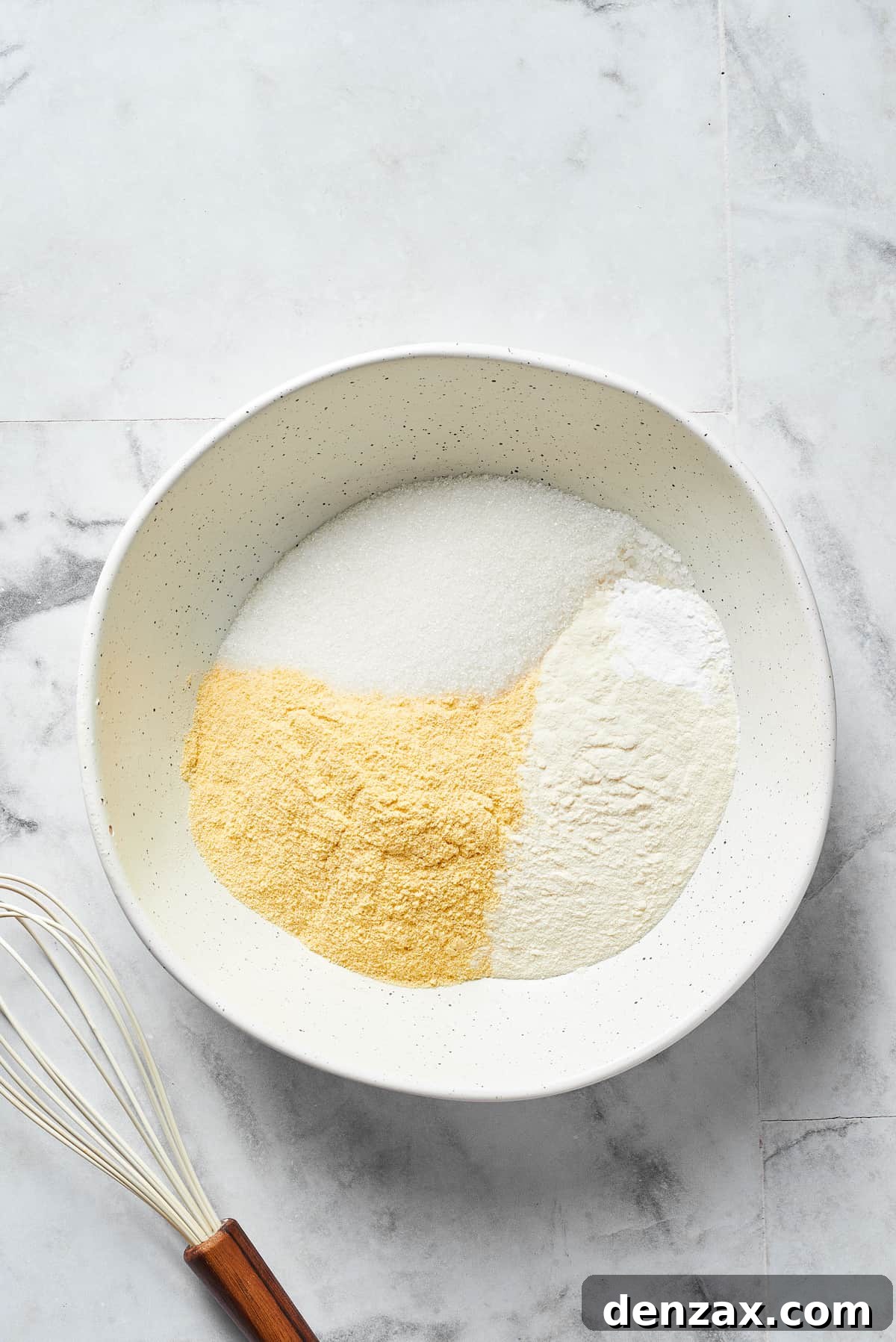 Dry cornbread ingredients in a bowl.