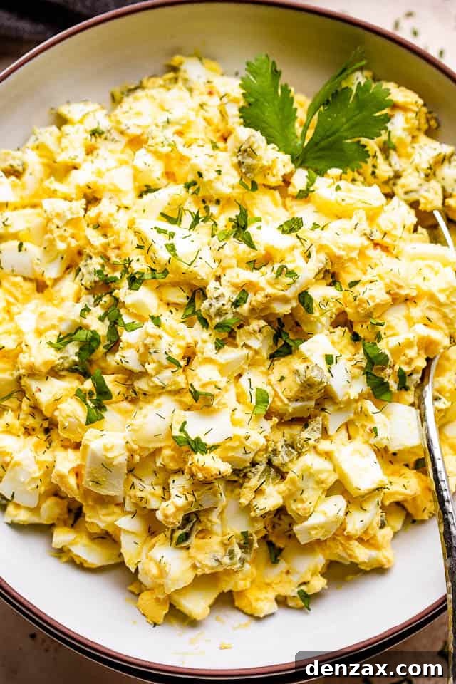 scooping out egg salad from a bowl