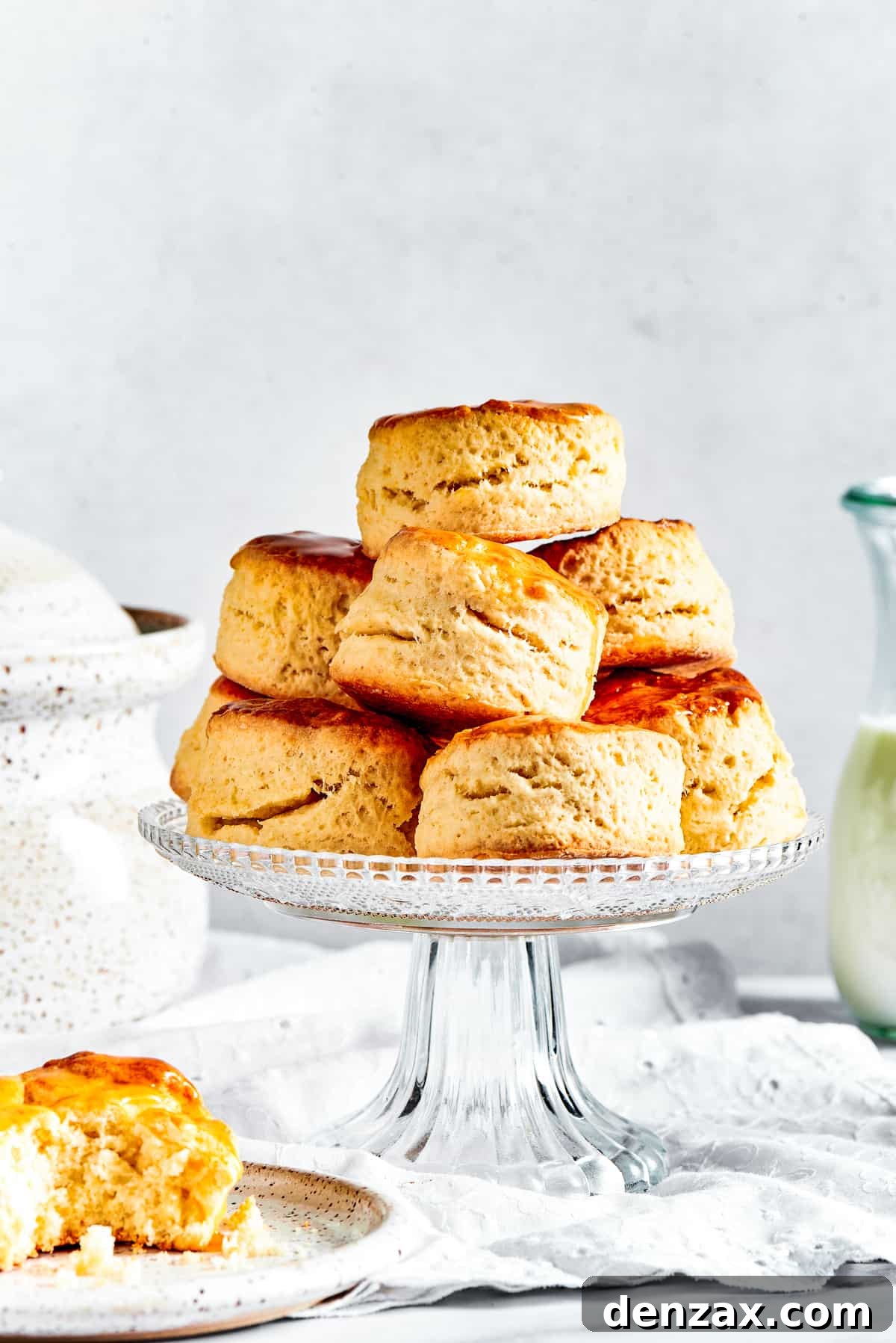 Biscuits on a cake stand, with one biscuit placed on a saucer.