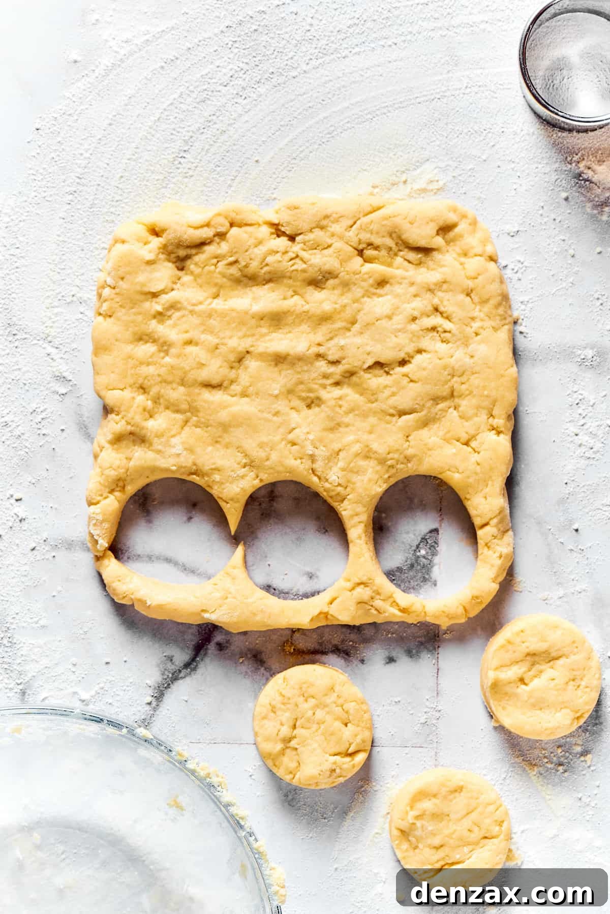 Cutting biscuits out of dough.