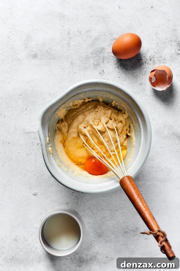 Crispy Homemade Waffles: Simple Recipe for Fluffy Breakfast 4 Mixing eggs and buttermilk into waffle batter.