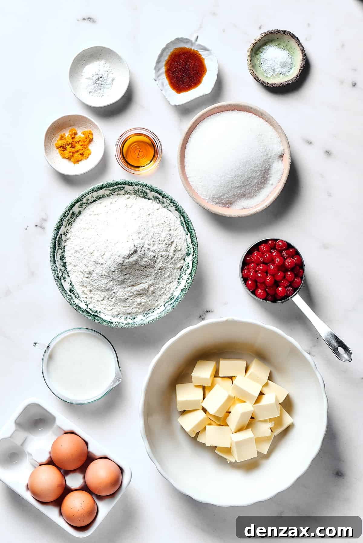 From top left: Baking powder, vanilla, salt, orange zest, orange liqueur, sugar, flour, cranberries, buttermilk, butter, eggs.