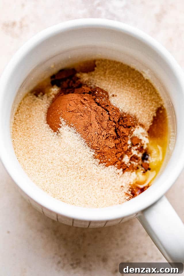 Cocoa powder, flour, and butter in a mug.