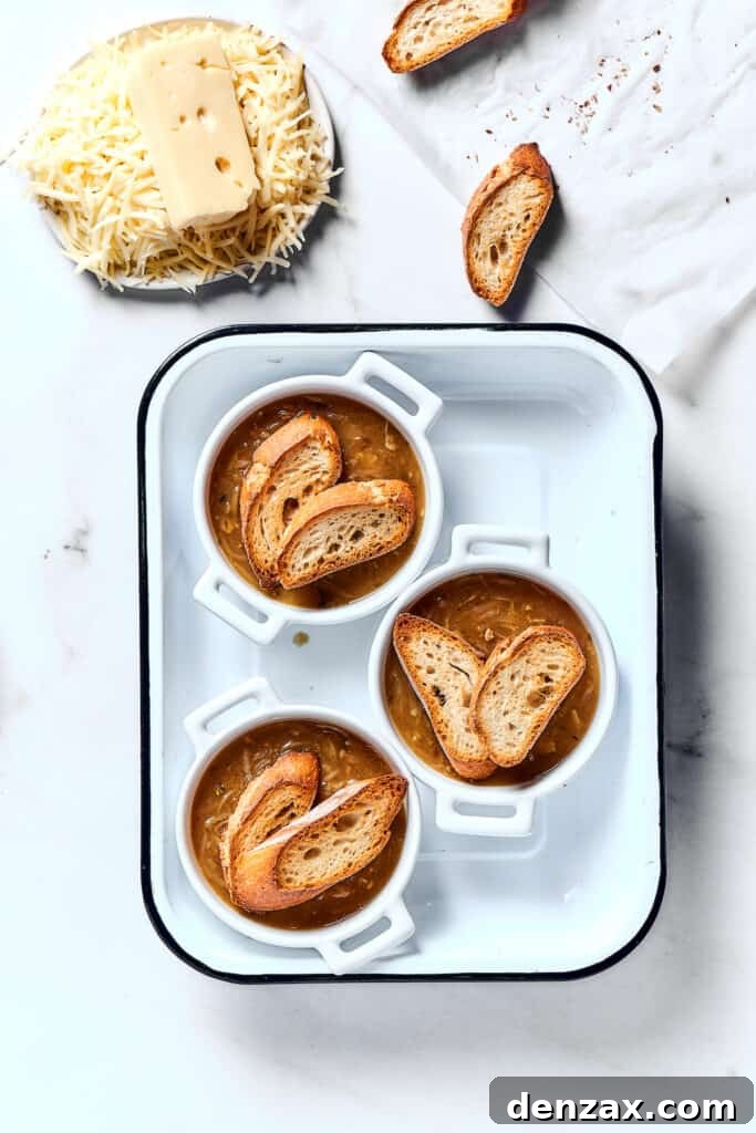 Individual oven-proof bowls of soup topped with toasted baguette.