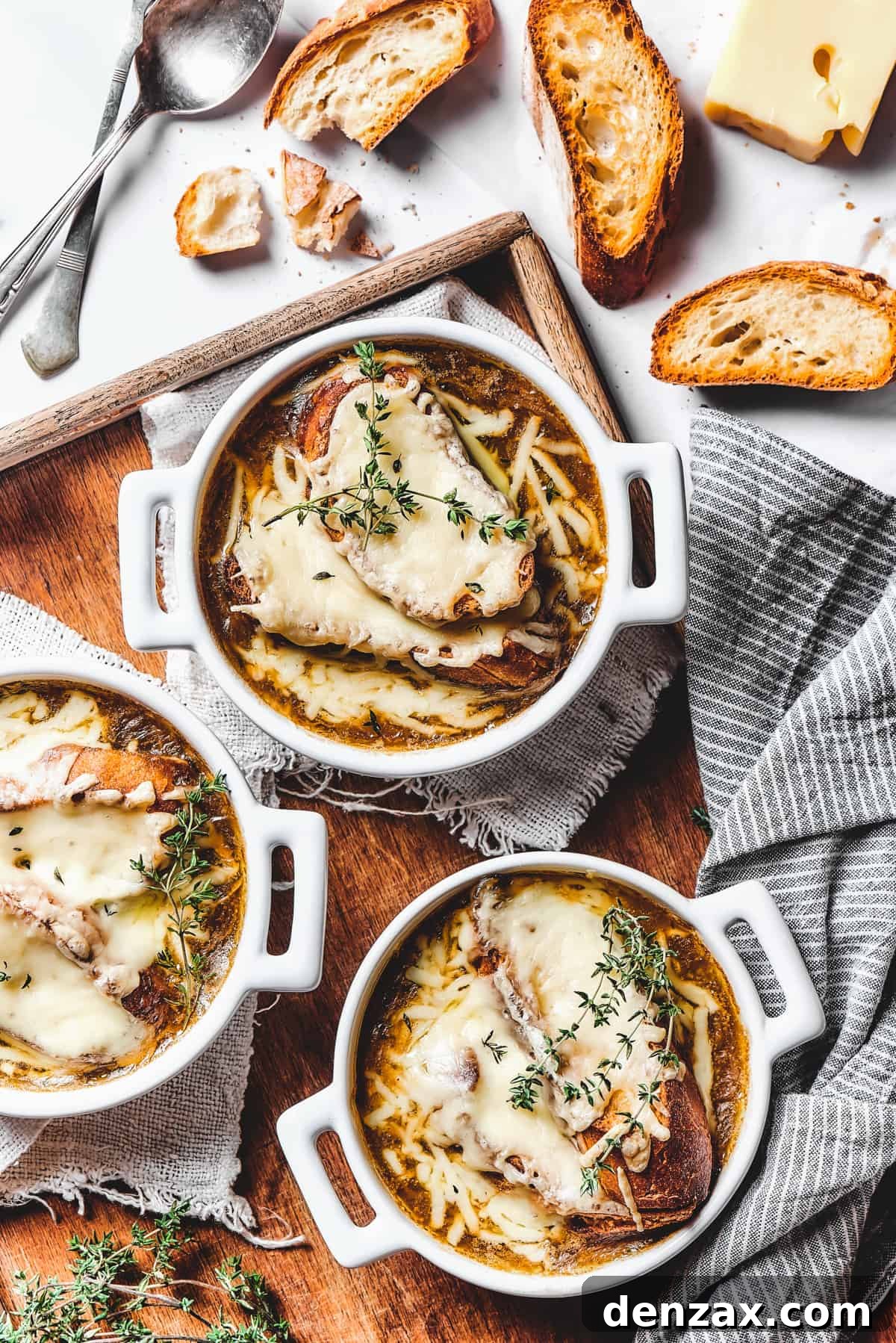 Onion soup with cheese croutons in individual bowls.
