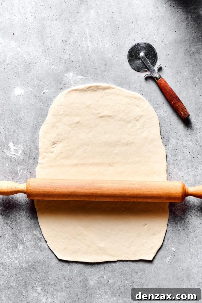 Rolling out dough on a work surface.