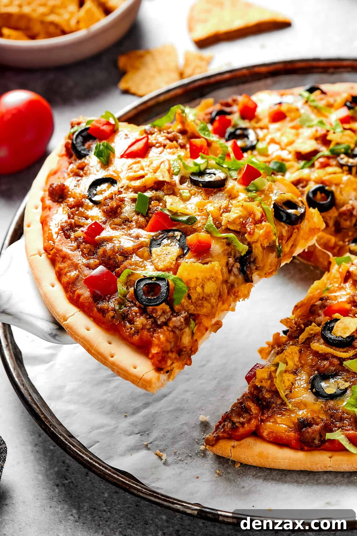 Lifting a slice of Southwestern pizza with a pie server.