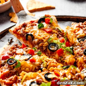 Lifting a slice of taco pizza with a pie server.
