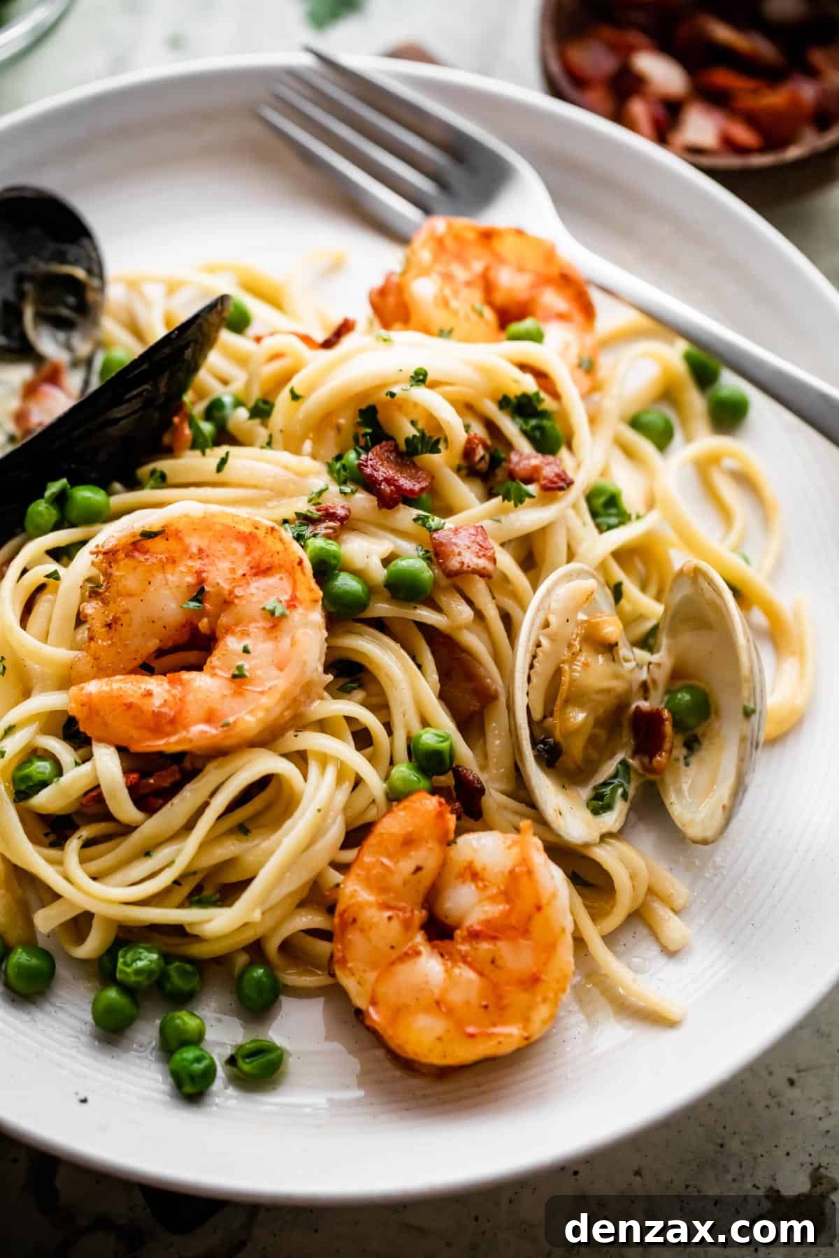 Creamy Seafood Pasta Recipe: Easy, Flavorful Weeknight Dinner 3 close up shot of a dinner plate with Creamy Pasta with shrimp and mussels.