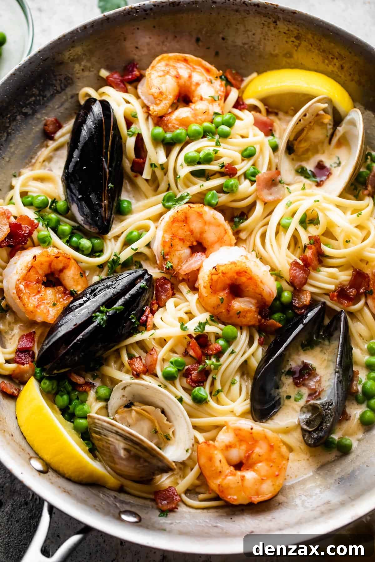 Creamy Seafood Pasta Recipe: Easy, Flavorful Weeknight Dinner 4 a skillet with pasta, shrimp, and mussels in cream sauce.