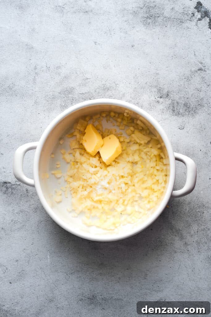 Cooking onions and butter in a soup pot.